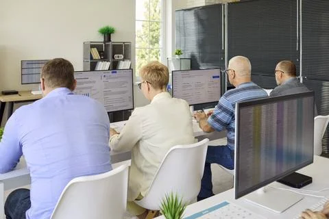 Adult students in computer training classroom, workplace learning session rear 写真素材