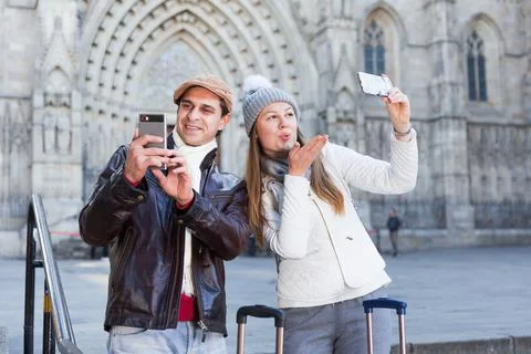 Adult tourists taking selfie on mobile phone Stock Photos