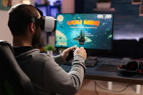 Adult using vr goggles to win video games on computer Stock Photos
