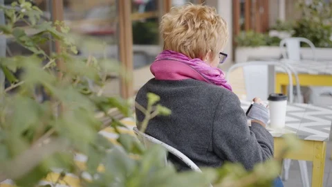 Adult woman with coffee and smartphone Stock Footage