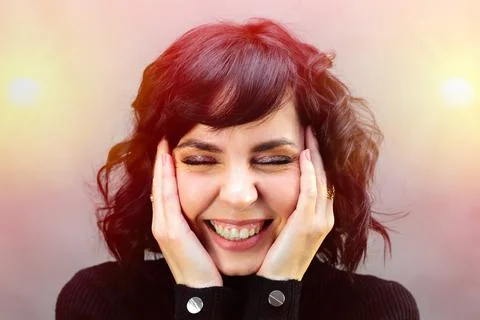 Adult woman laughs closing her eyes in neon light Stock Photos