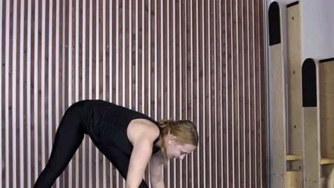 Adult woman performs an exercise to develop muscles of arms, legs and spine. Video stock 85712615