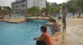 Adults and children relaxing by the pool at Playa Blanca Resort, Panama 4k or 4k+ Resolution
