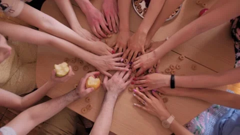 Adults are sitting at the table and, like children, they grab the drying things Stock Footage 194368226