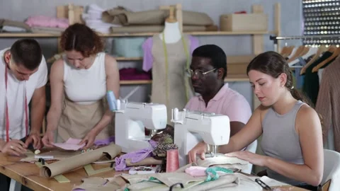 Adults focusing on sewing and pattern work during beginner workshop 스톡 동영상 330398635