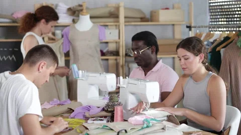 Adults focusing on sewing and pattern work during beginner workshop Stock Footage 344849255