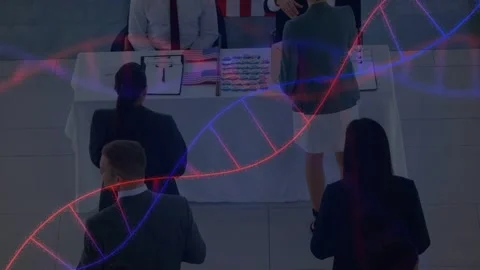 Adults queuing at register table, registering, staff handing forms, helix Stock Footage 333999693