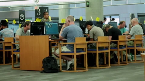 Adults using computer in a library Stock Footage 51772804
