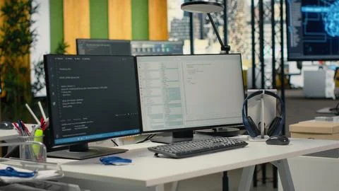 Advanced AI algorithms running on computer monitors in empty startup workspace Stock Photos