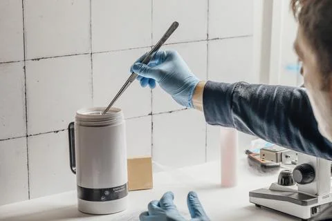 Advanced equipment in a laboratory, including a microscope and a semen thaw Stock Photos