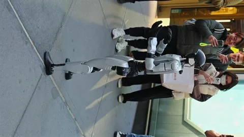 An advanced humanoid robot dancing among a crowded Manhattan sidewalk during Stock Footage 332817456