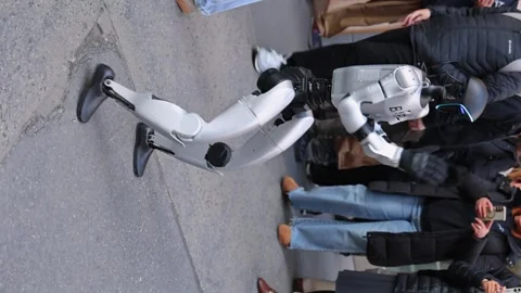 An advanced humanoid robot walking along a crowded Manhattan sidewalk during Stock Footage 332890560