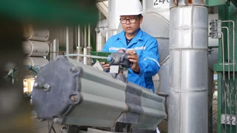 Advanced oil refinery facility with engineers overseeing petroleum processing an Stock Footage 330585308