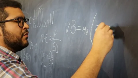 Advanced physics mexican student sketching equations on blackboard 스톡 동영상 124664355