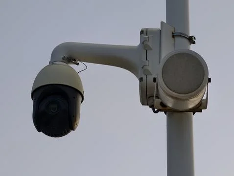 Advanced security camera installed on pole overseeing city intersection at .. Stock Photos