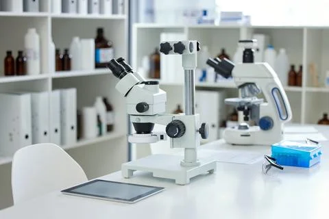 Advancing the world through science and technology. a microscope and digital 스톡 사진