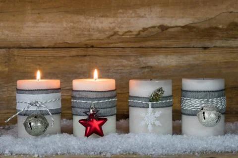 Advent or Christmas time decoration with candle flames and ornaments Stock Photos