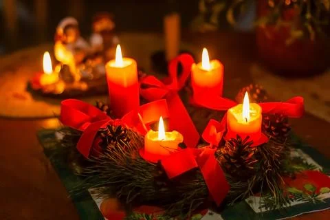 Advent wreath made of pine branches with four burning candles Stock Photos