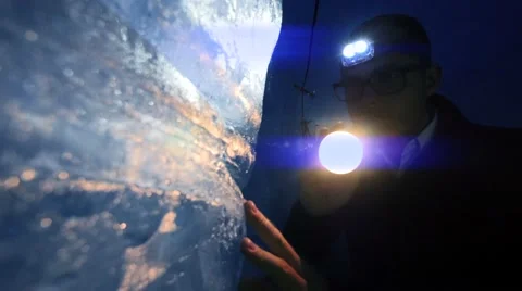 Adventure background of person using flashlight to discover ice glacier cave Stock-Footage 64799564