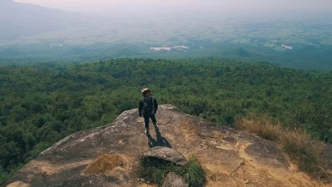 Adventure biker at cliff viewpoint Stock Footage 82226510