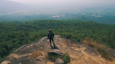 Adventure biker at cliff viewpoint Stock Footage 82226926