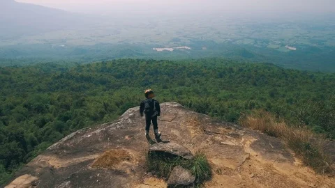 Adventure biker at cliff viewpoint Stock Footage 82226936