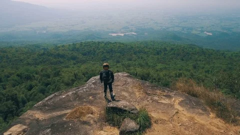 Adventure biker on a cliff viewpoint Stock Footage 82233481