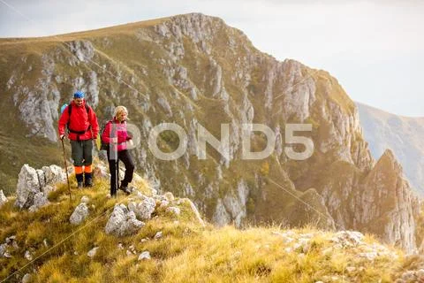 Adventure, travel, tourism, hike and people concept - smiling couple walking Stock Photos