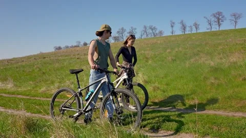 Adventure of Two Bikers Exploring Green Nature Trails Stock Footage 309476977