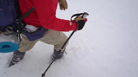 Adventurer Walking Through Deep Snow Using Hiking Sticks 動画素材 315880662