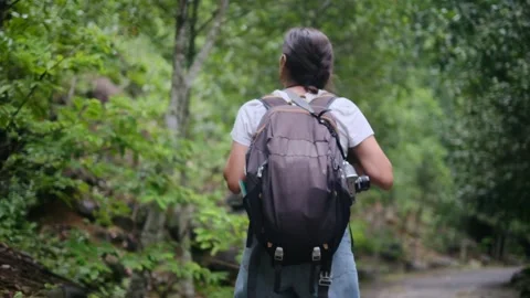 Adventurous backpacker as she embarks on a journey through lush jungles Stock Footage 252036000