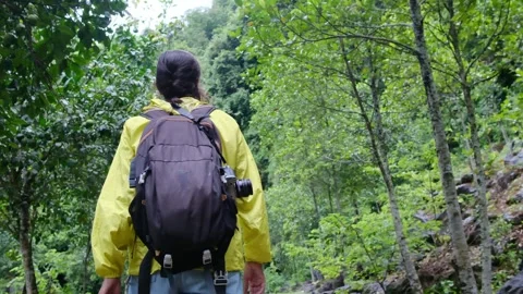 Adventurous backpacker as she embarks on a journey through lush jungles Stock Footage 252036158