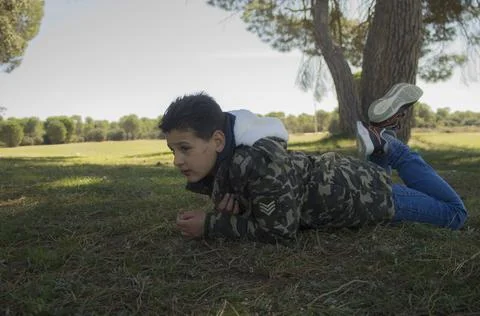 Adventurous child lying on the ground Foto stock