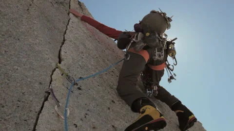 Adventurous climber scaling a steep rock face Stock Footage 335093603