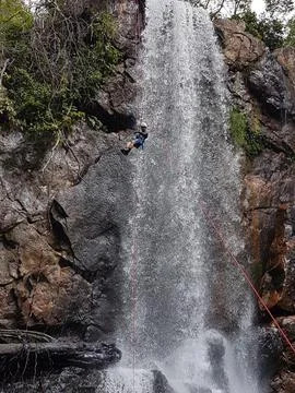 Adventurous climber at waterfall Stock Photos
