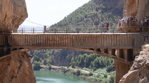 Adventurous climbers crossing the Caminito Del Rey suspension bridge Stock Footage