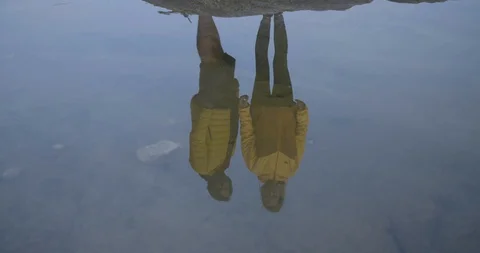 Adventurous couple reflection on stable water of the river Video stock 85963205