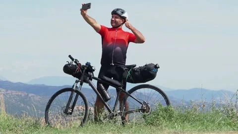 Adventurous cyclist man taking a selfie during his trip. Bikepacking, adventures Stock Footage 164416457