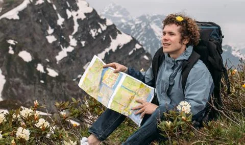 Adventurous explorer is studing the map while travelling. Stock Photos