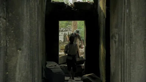 Adventurous explorers walking inside ancient temple ruins in Cambodia 库存影片 331946915