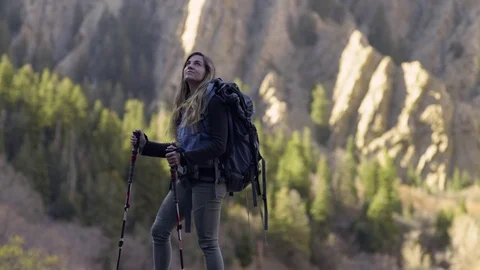 Adventurous Female Backpacker Takes In Mountain Views, Turns Around Stock Footage 70372579