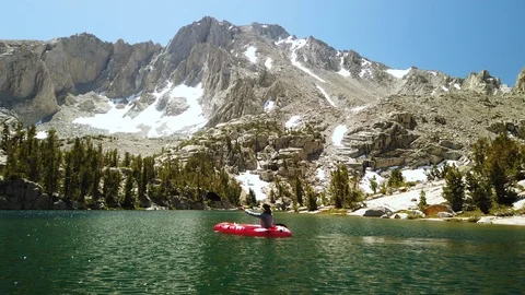 Adventurous Female Kayaks Paddles Across Lake, High Sierra Mountains Backcountry Stock Footage