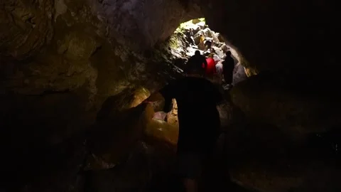 Adventurous group exploring the dark Jumandy Caves Vídeos de archivo 334934269