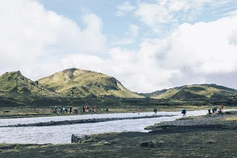 Adventurous hikers crossing river while hiking famous Laugavegur trail Stock Photos