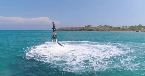 Adventurous Man Riding A Jet Fly Board In Turquoise Water Beach on Tropical Stock Footage 79250497