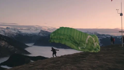 Adventurous Paraglider Jumps Over Cliffside Towards A Beautiful View Of Video stock 147609200