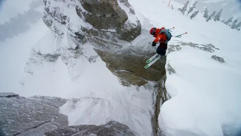 Adventurous skier jumping from the rock in high mountains Stock Footage 116746209