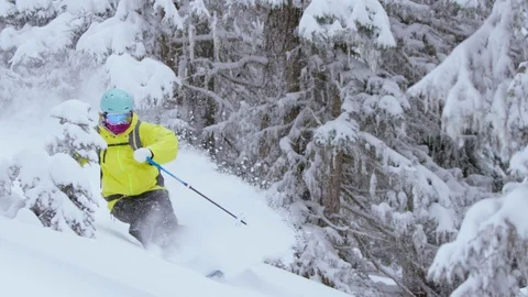 Adventurous skier making turns while skiing down the snowy mountain slope Stock Footage 116740067
