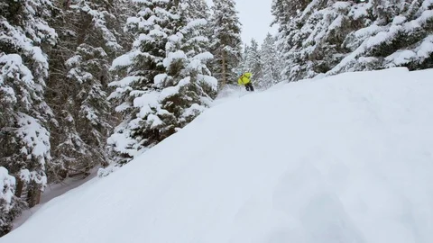 Adventurous skier making turns while skiing down the snowy slope Stock Footage 116740888