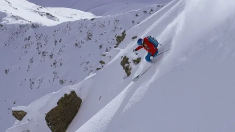 Adventurous skier making turns while skiing down the mountain Stock Footage 116741089